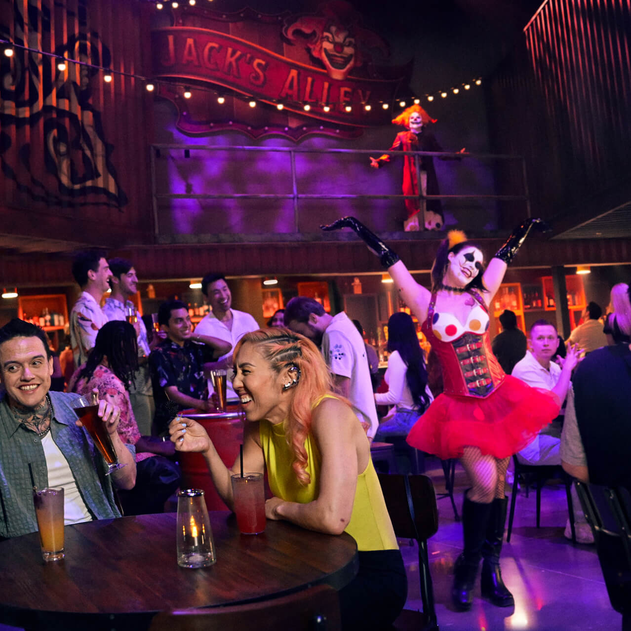 Guests laughing and drinking at tables while a Chance walks around Jack’s Alley bar.