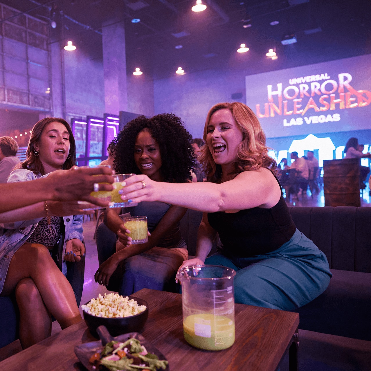 Group of guests toasting drinks inside Universal Horror Unleashed Las Vegas.