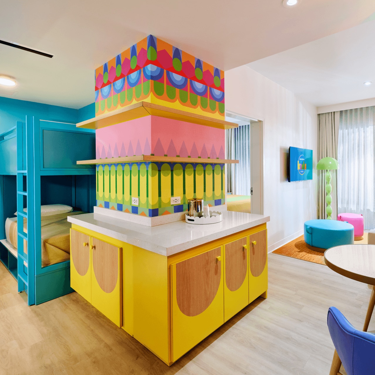 Family Room with blue bunk beds, storage, sitting area and a living space with TV.