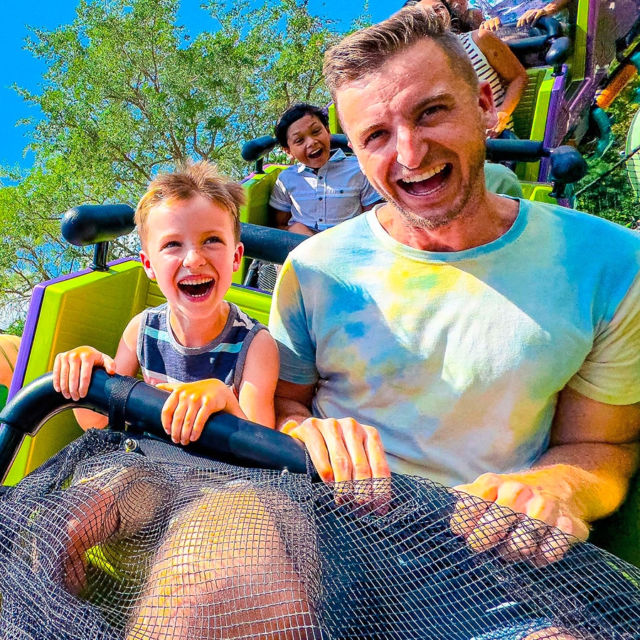  A father and son smile on a rollercoaster at Universal Kids Resort.