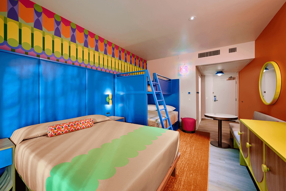 Standard room with blue bunk beds, a full bed, and a sitting area.