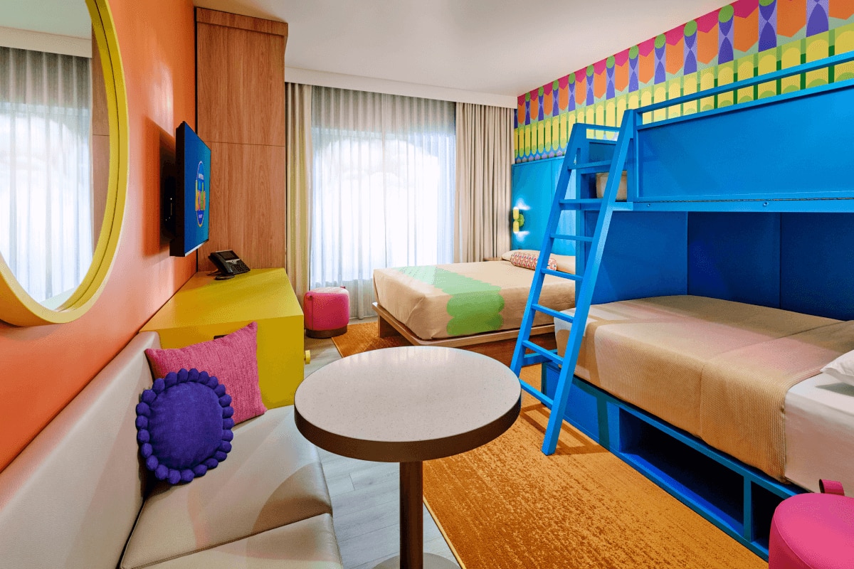 Standard room with blue bunk beds, a full bed, and a sitting area.