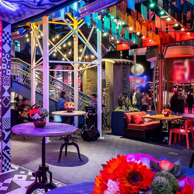 Antojitos Interior, showcasing tables, flowers, and stairs