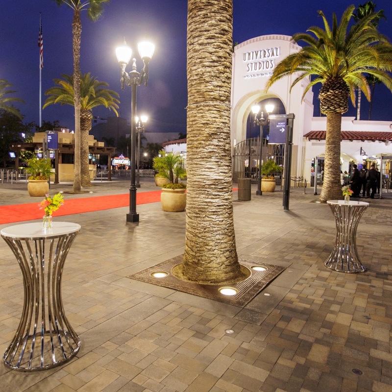Red carpet and tables near the arch at the entrance to Universal Studios Hollywood.