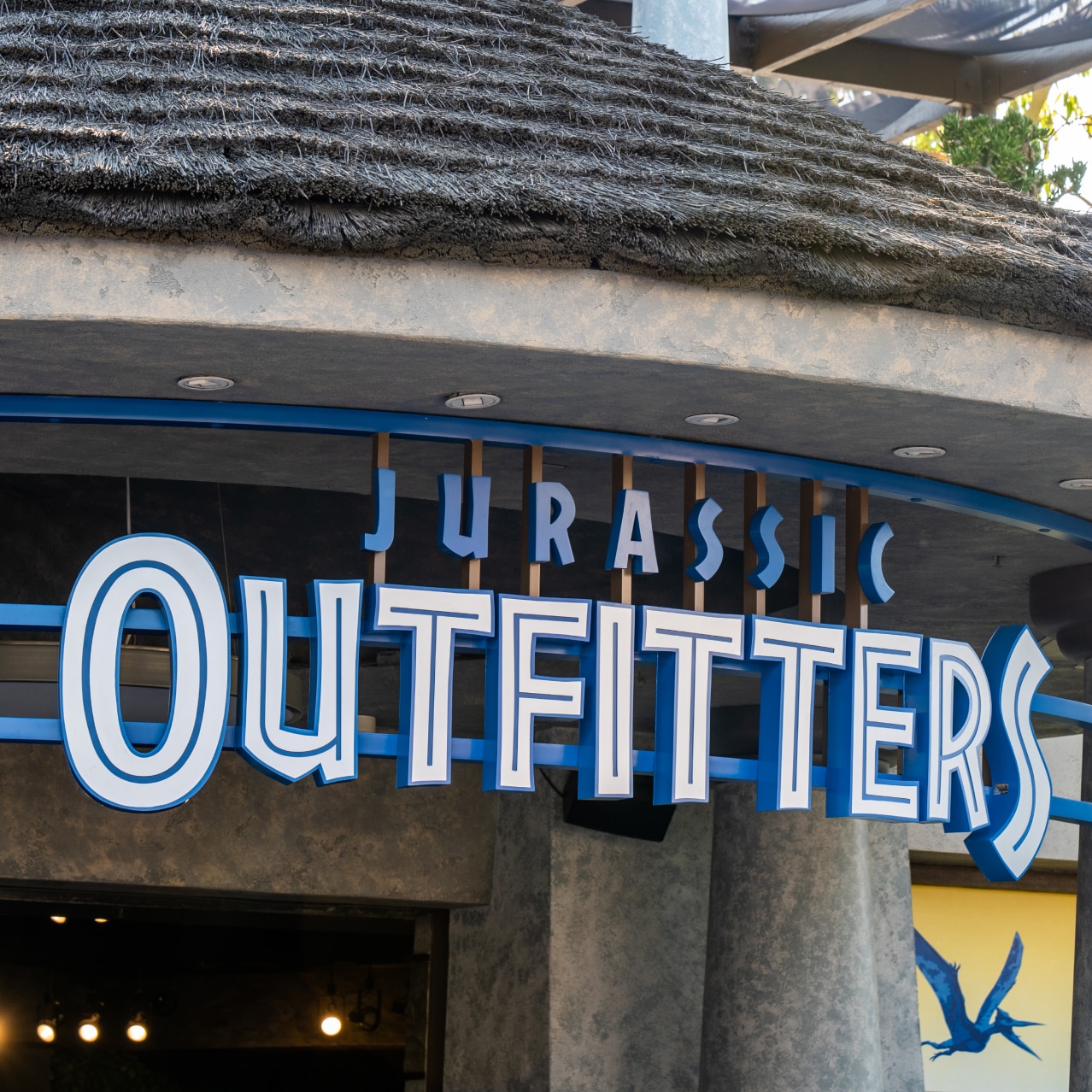 The sign hanging above the entrance to Jurassic Outfitters.