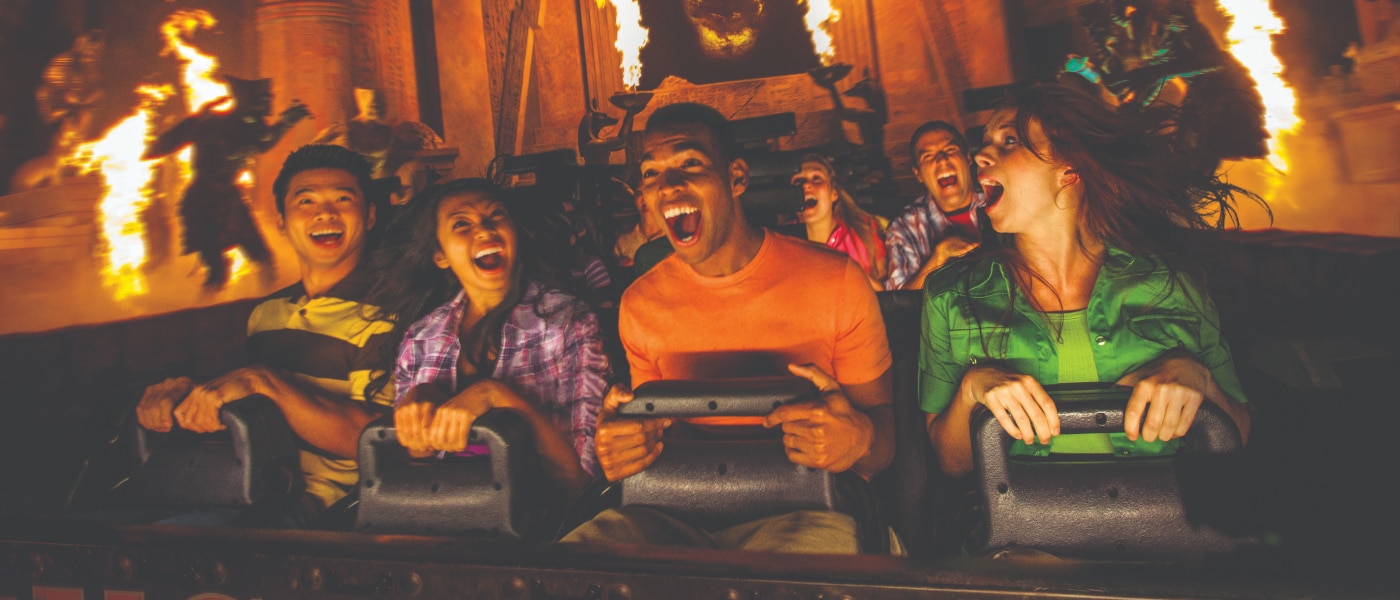 Guests smiling in excitement as they ride Revenge of the Mummy – The Ride.
