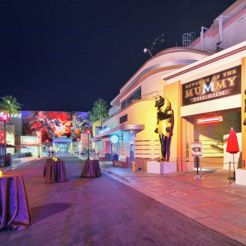 Candlelit tables set up in front of the entrance to Revenge of the Mummy – The Ride.