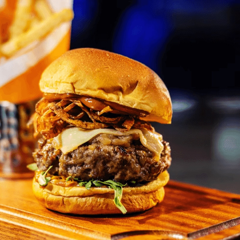Meal consisting of a hamburger, fries and a beer