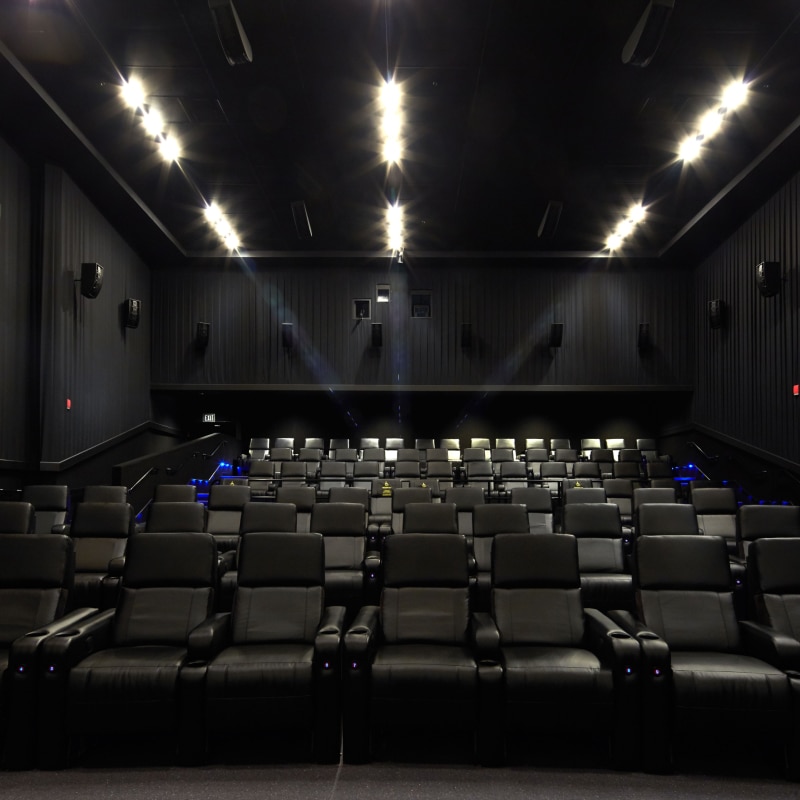 An empty movie theater full of seats inside Universal Cinema.