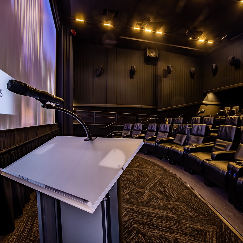 A podium set up in a theater, facing the seats at Universal Cinema