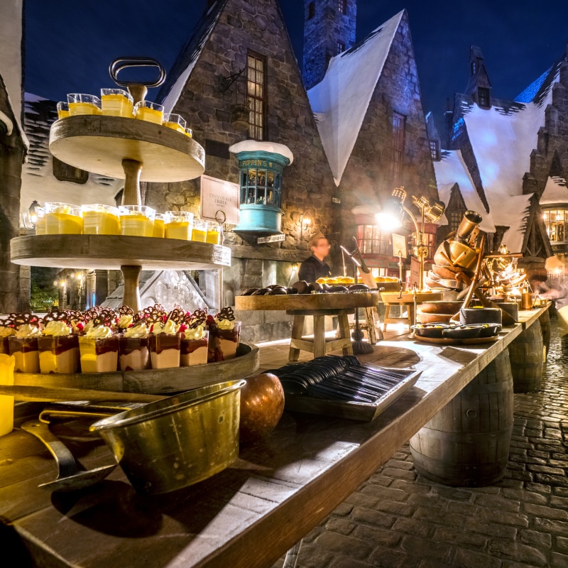 Desserts lined on a table for an event inside of Hogsmeade™ in The Wizarding World of Harry Potter.