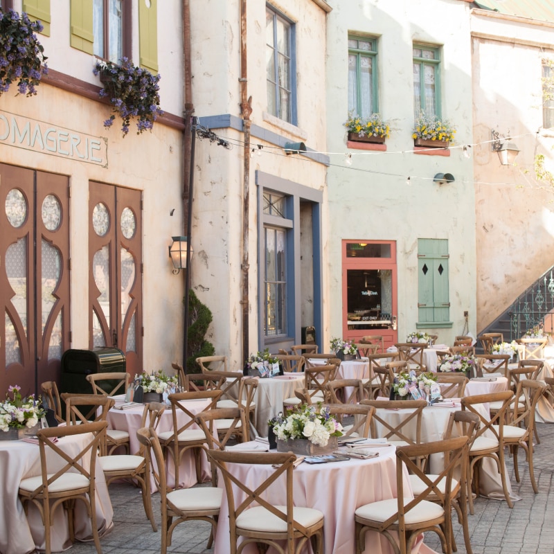 Parisian Courtyard with tables and chairs set up inside Universal Studios Hollywood.