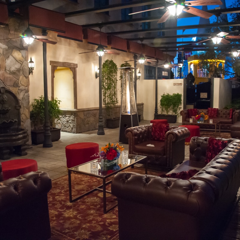 Couches and tables set up at night inside of Parisian Courtyard at Universal Studios Hollywood.