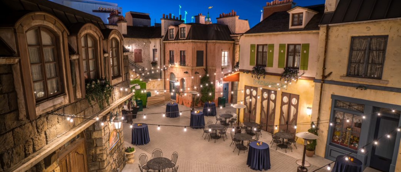 Parisian Courtyard at night with string lights hanging above inside Universal Studios Hollywood.