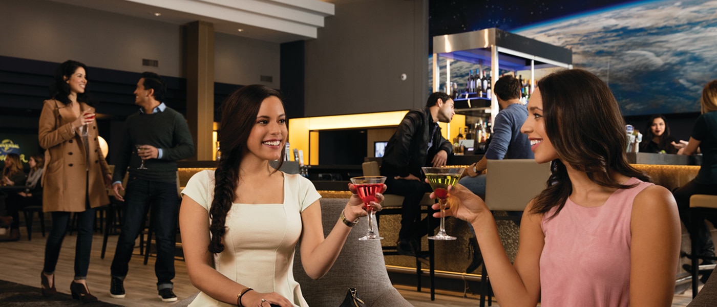 People enjoying drinks and cocktails at the bar at Universal Cinema