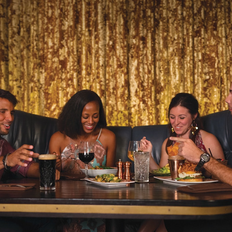 Group of friends enjoying dinner and drinks at Toothsome Chocolate Emporium & Savory Feast Kitchen