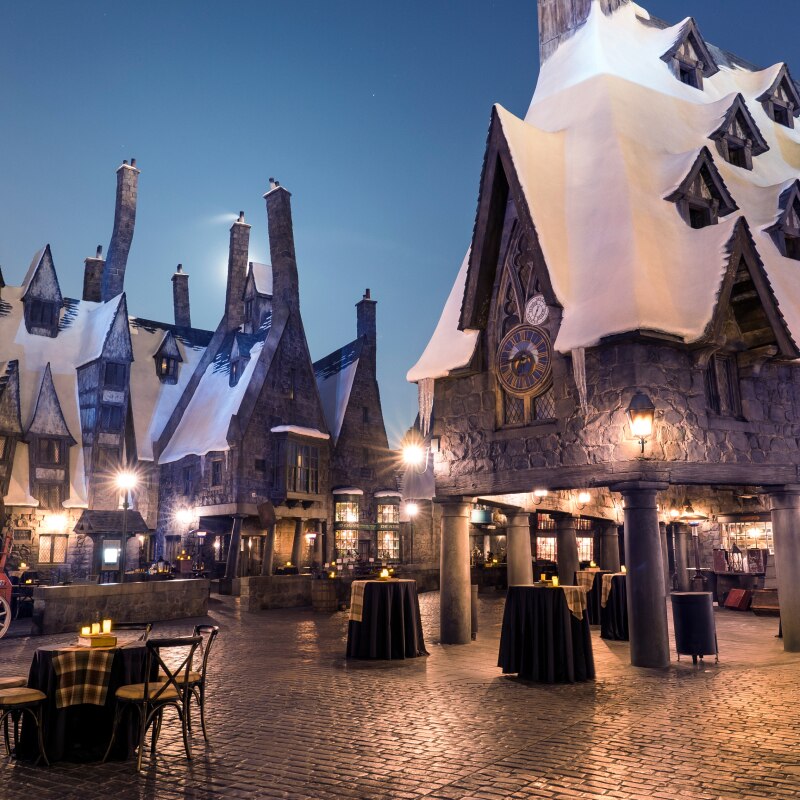 Tables set up for an inside of Hogsmeade™ in The Wizarding World of Harry Potter.