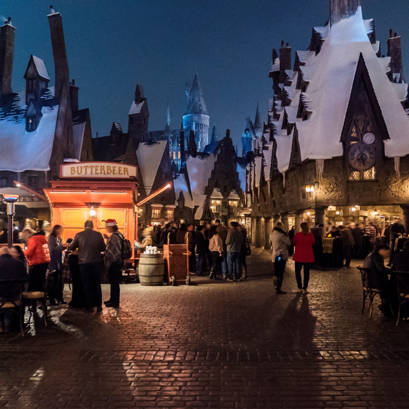 Guests enjoying a nighttime event inside of Hogsmeade™ in The Wizarding World of Harry Potter.