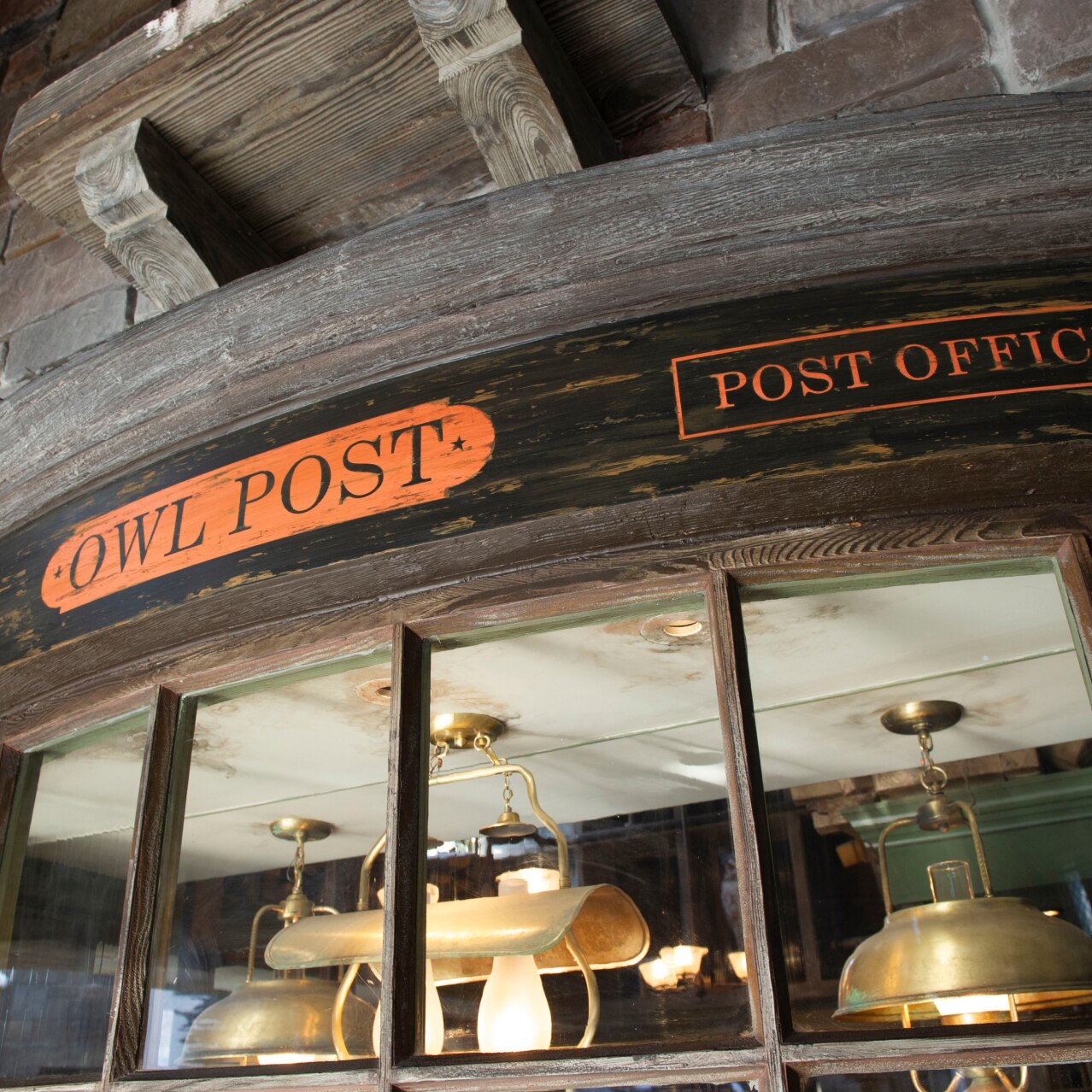 The outside of the Owl Post which is black with stone and a red label.