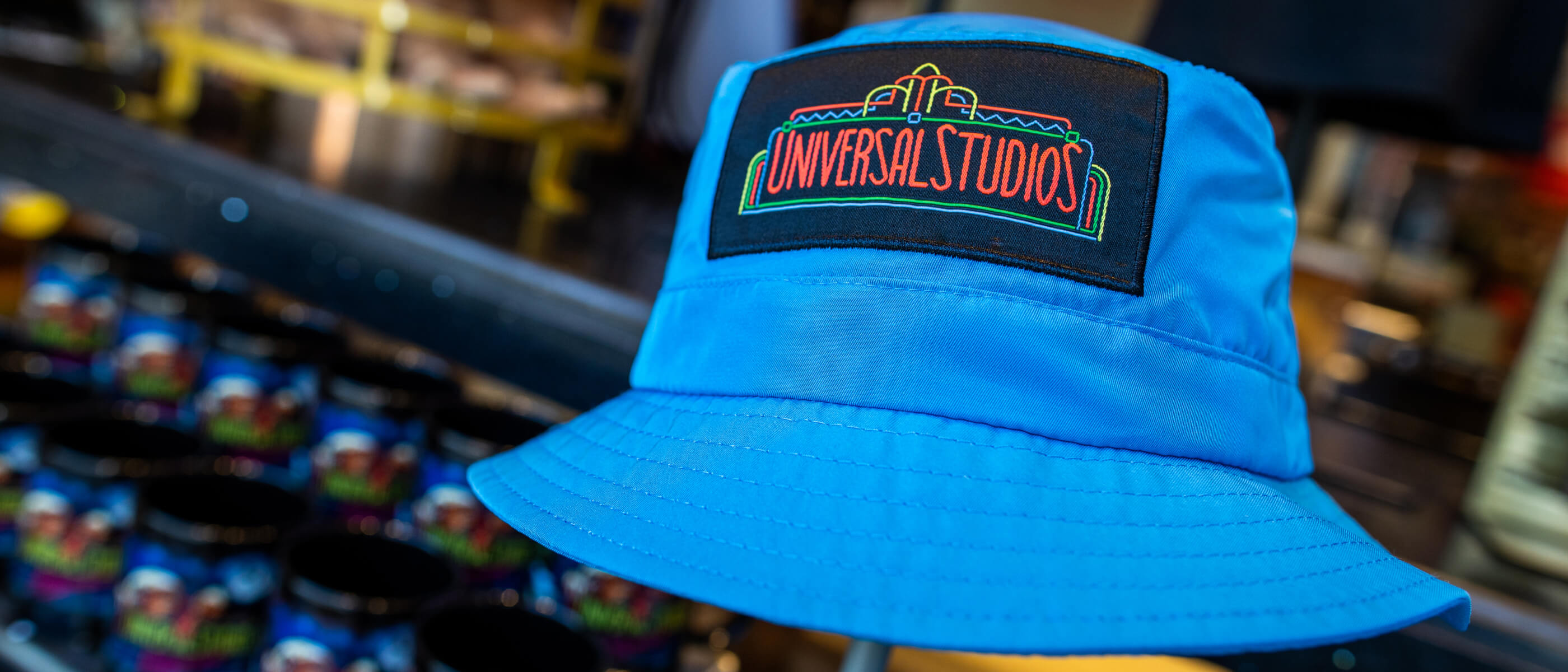 A blue bucket hat featuring a colorful Universal Studios logo in the center.