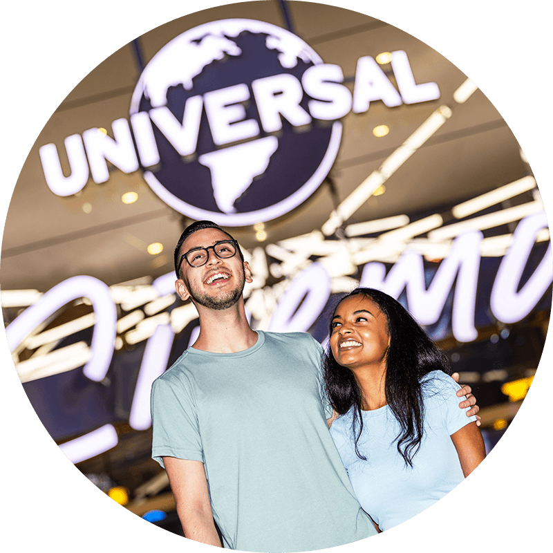 A couple stands smiling in front of Universal Cinema at Universal CityWalk Hollywood.