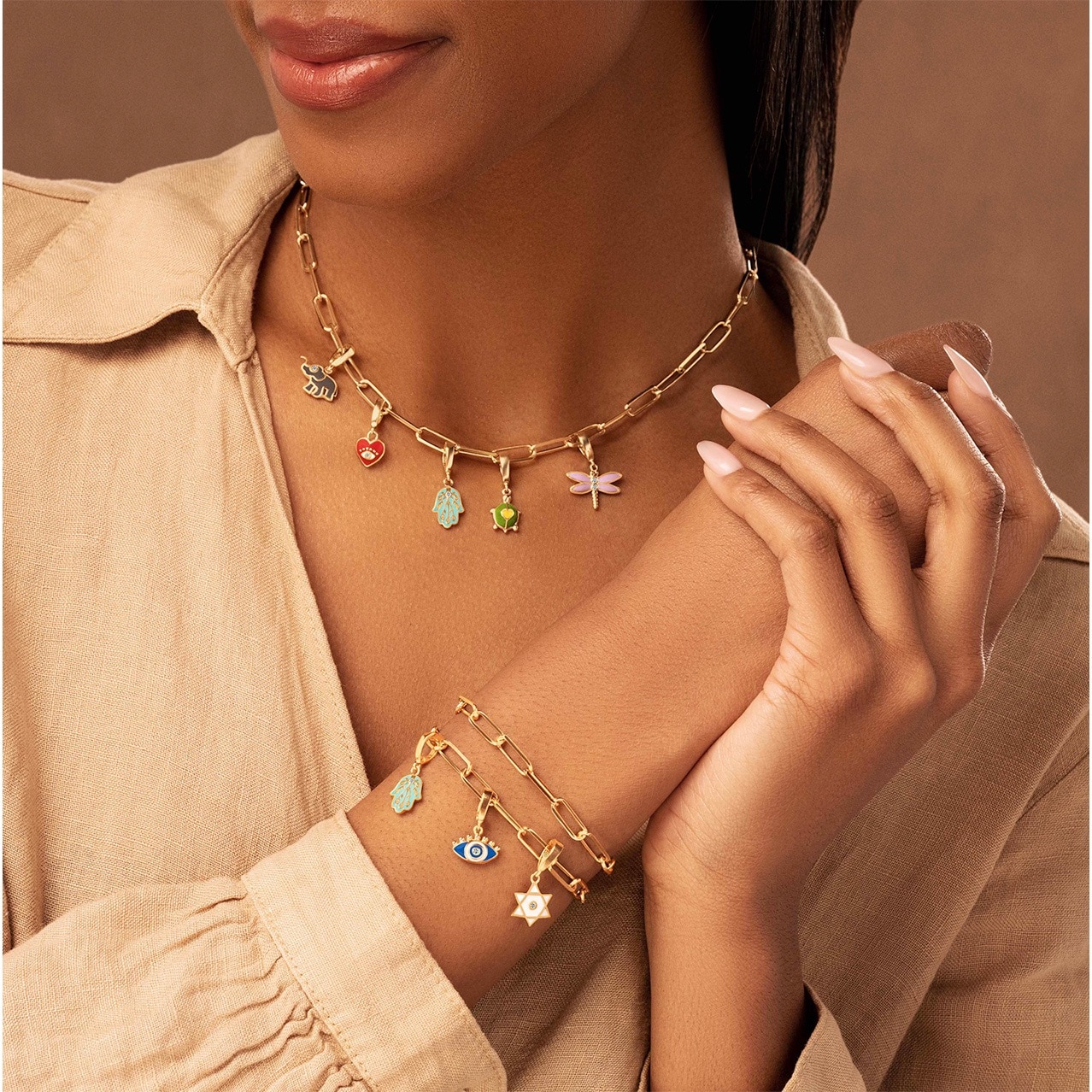 A woman wearing a charm bracelet and necklace from Karma and Luck at Universal CityWalk Hollywood.