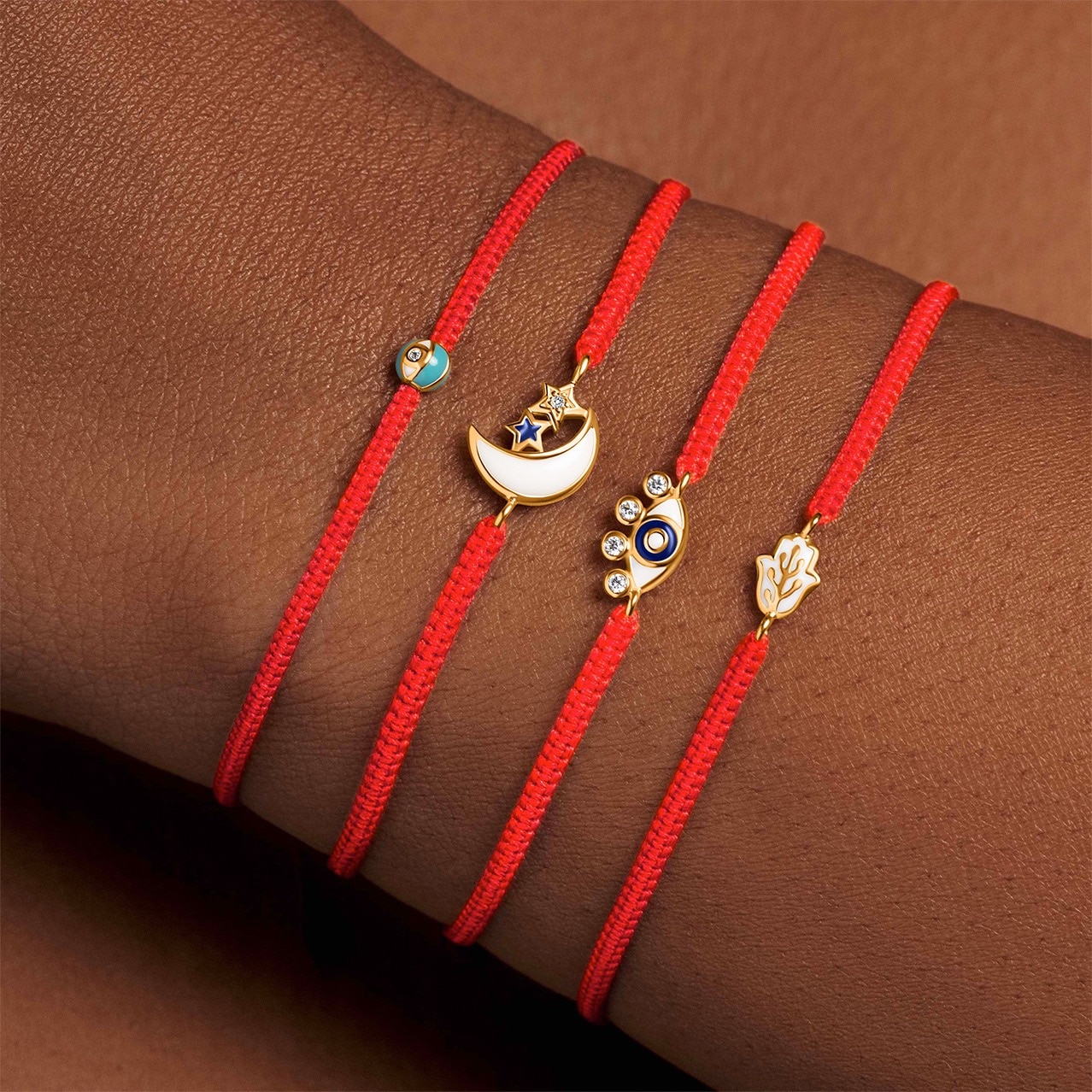 Four red bracelets on a wrist from Karma and Luck at Universal CityWalk Hollywood.