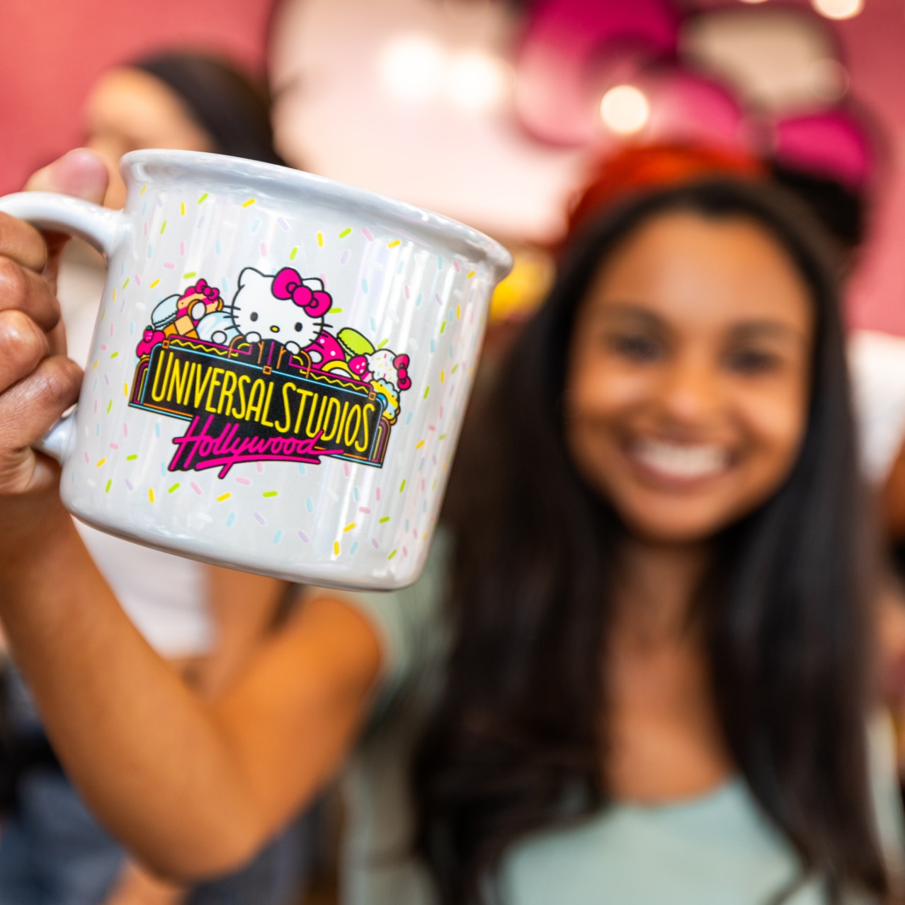 A guest holds a Universal Studios Hollywood-Hello Kitty mug inside the Sanrio Smile Shop at Universal CityWalk Hollywood.