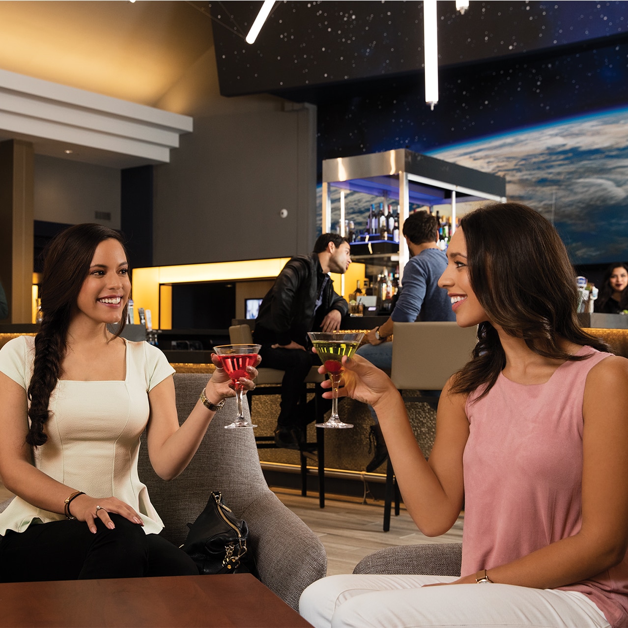 Two women share a cocktail inside the bar of Universal Cinema at Universal Citywalk Hollywood.
