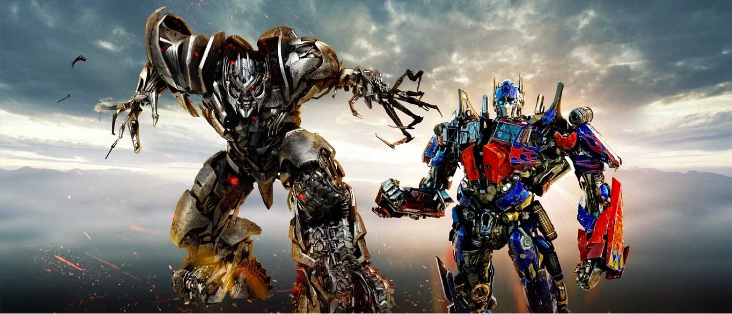 Megatron lunges forward while Optimus Prime stands firm, from the Transformers ride.