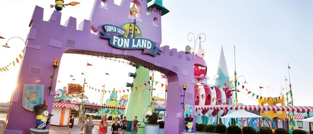 Purple archway entrance to Super Silly Fun Land with people walking. Purple archway entrance to Super Silly Fun Land with people walking.