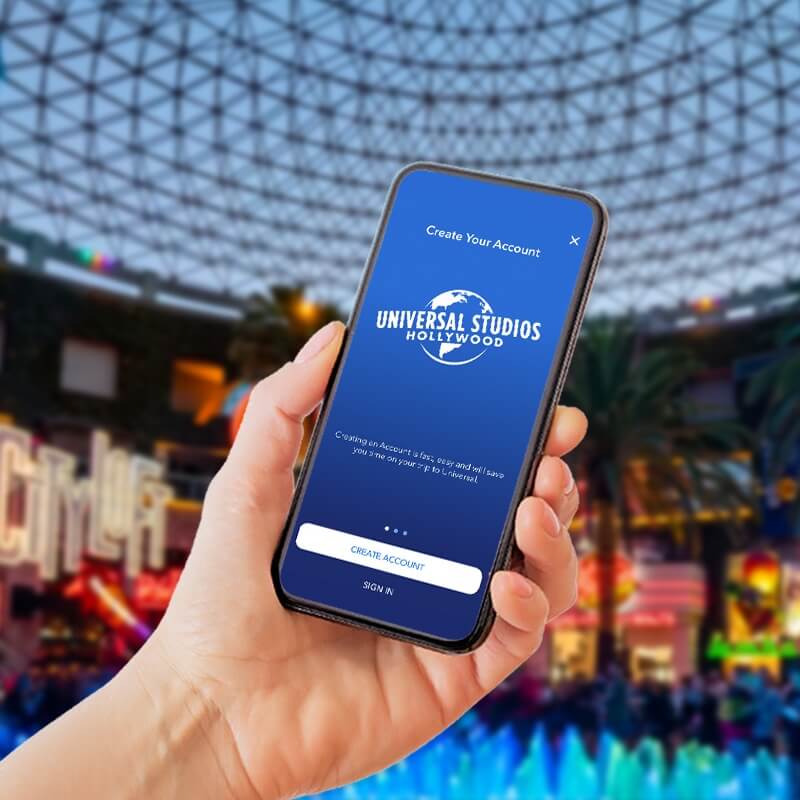 Person holding a phone with the Universal Studios Hollywood App inside a store.