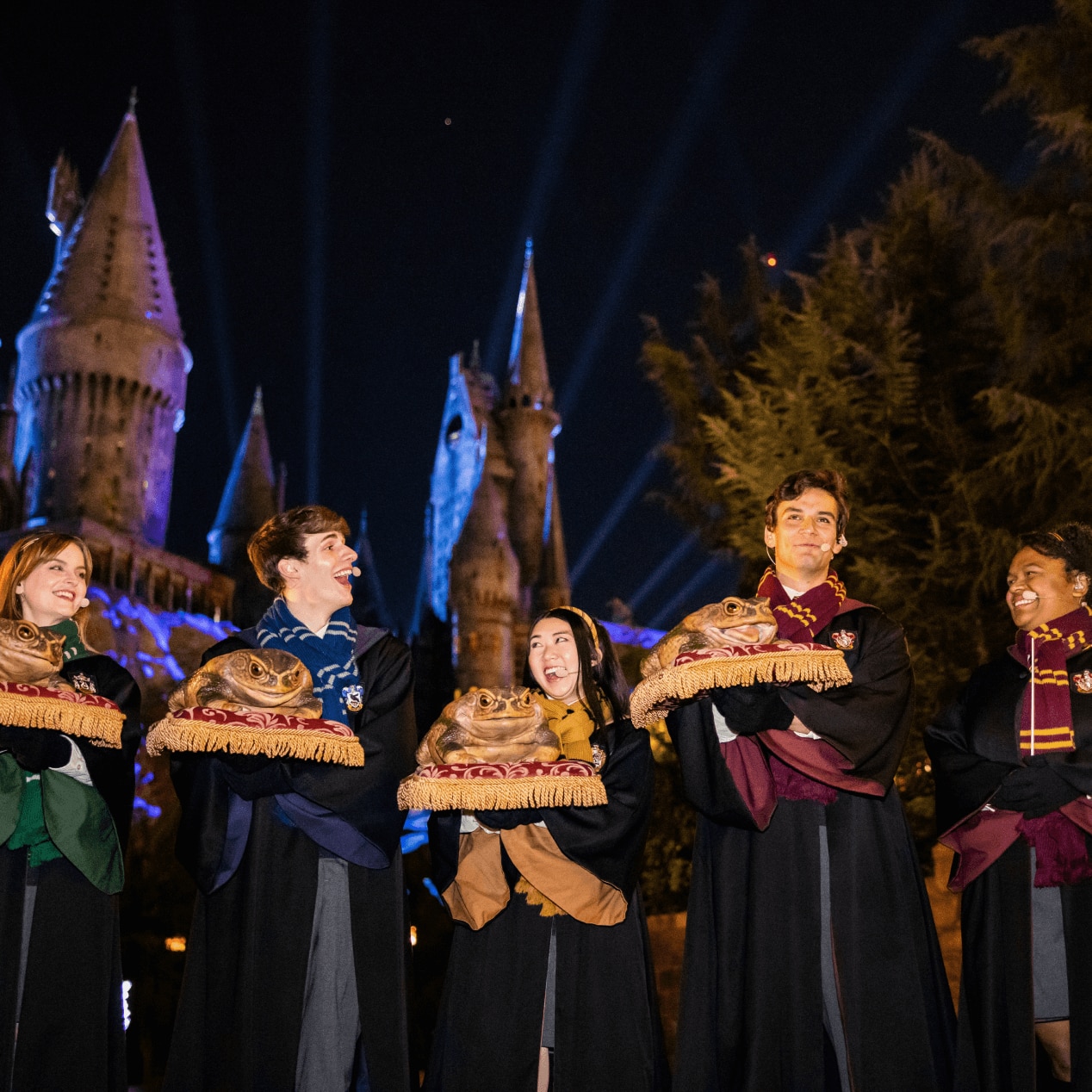 The Hogwarts Frog Choir singing together including students from all four houses.