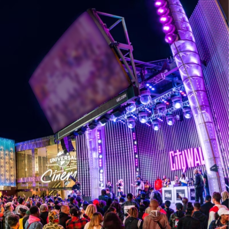 A large crowd gathers outside for a performance at the 5 Towers Stage at CityWalk Hollywood.