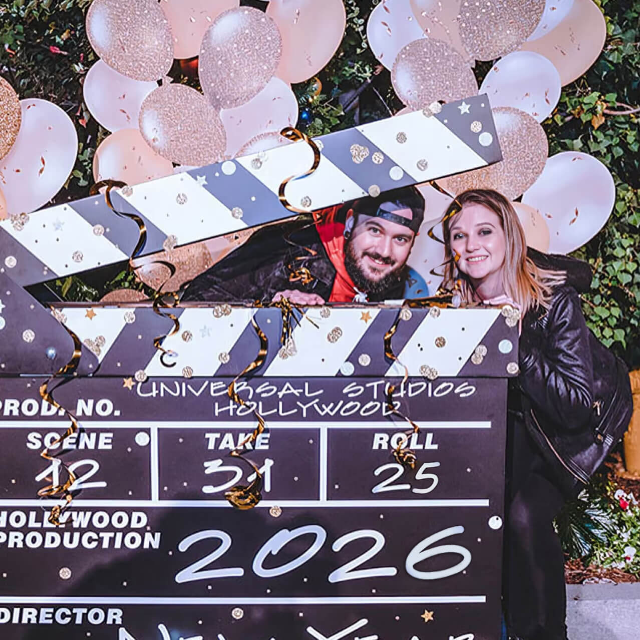 A young couple takes advantage of a giant New Year’s Eve clapperboard, a photo-op location at Universal Studios Hollywood’s Eve event