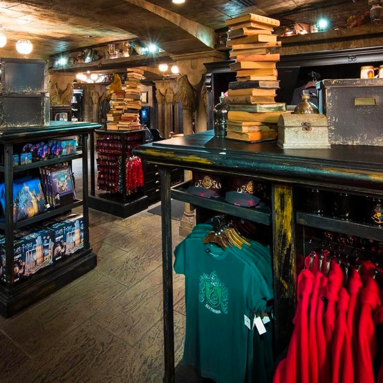 Harry Potter clothing store with stone walls and black shelves.