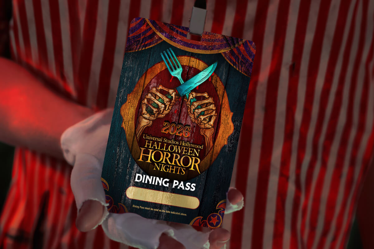A hand holding a lanyard with the words "2026 Universal Studios Hollywood Halloween Horror Nights Dining Pass."