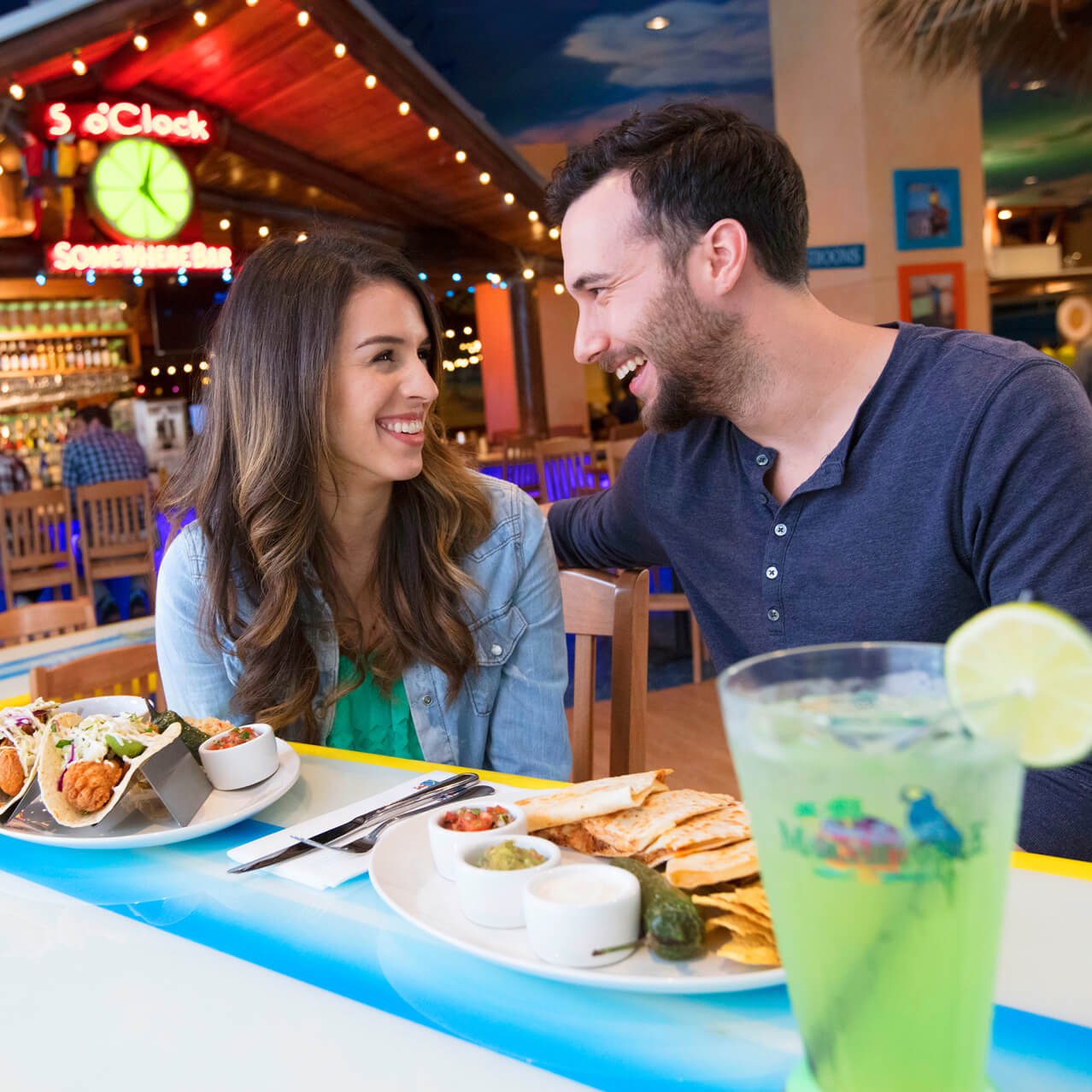 A couple enjoying dinner a meal at Jimmy Buffetts Margaritaville
