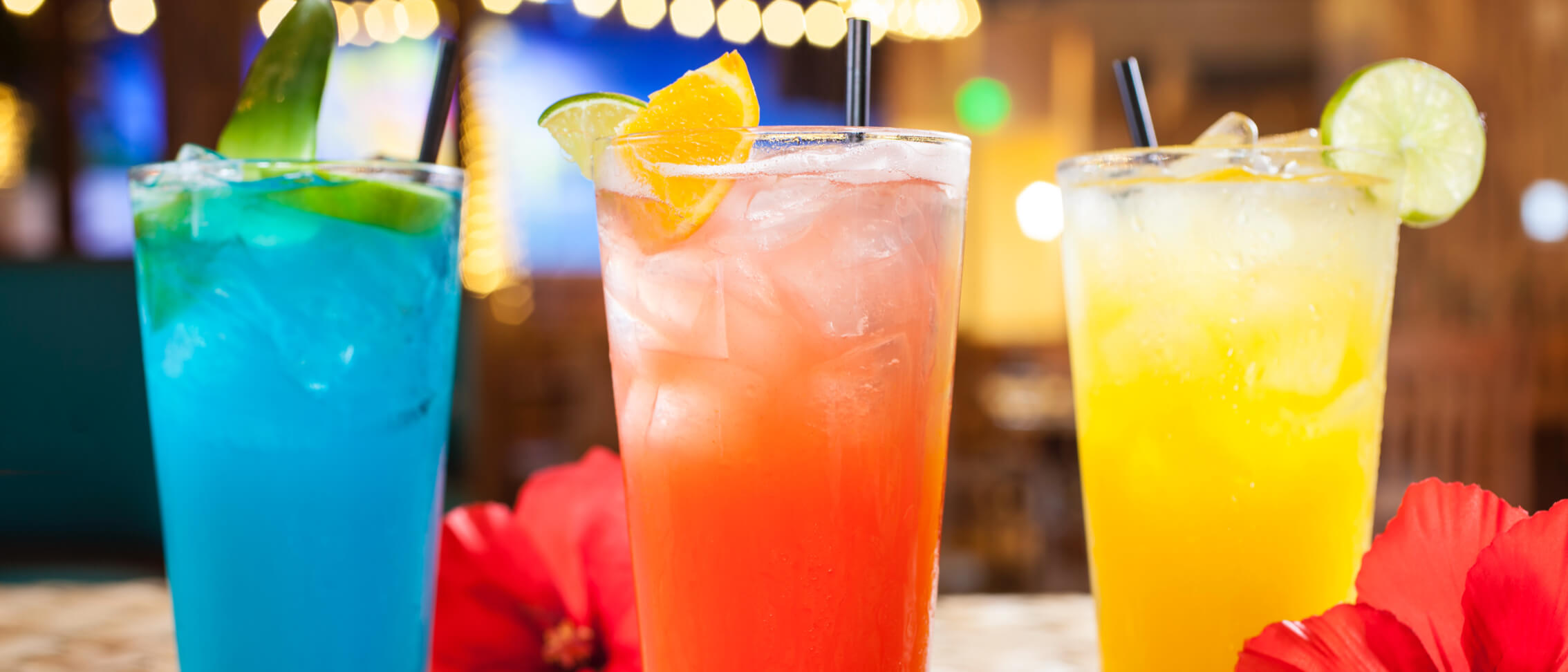One blue drink, one red drink and one yellow mixed drink from Jimmy Buffett's® Margaritaville®.