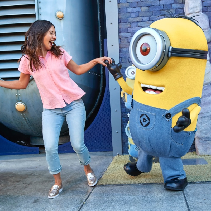 Guest and Minion pose for picture.