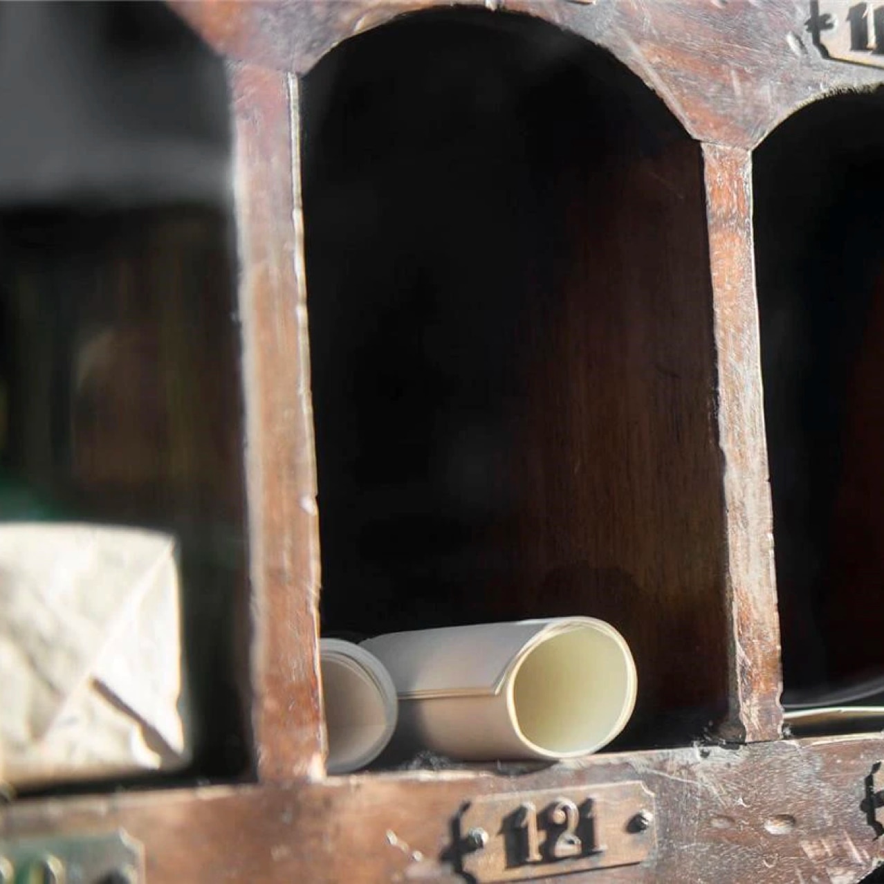 Old fashion mailboxes with rolls of parchment.