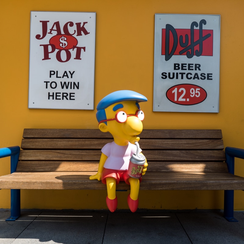 Milhouse sitting on bench in Springfield