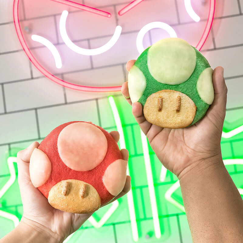 A red calzone and a green calzone themed as SUPER NINTENDO WORLD™ mushrooms.