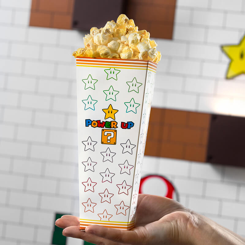 A SUPER NINTENDO WORLD™ POWER UP themed bucket, full of popcorn.
