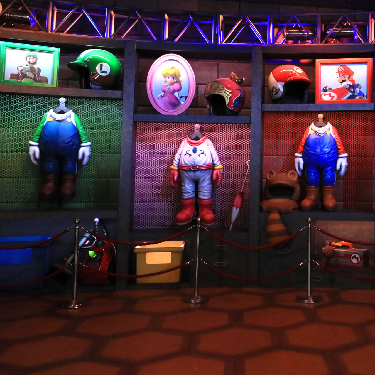 Wall displays in Bowser’s Castle each feature the outfit, racing helmet and portrait of a different Super Mario character.