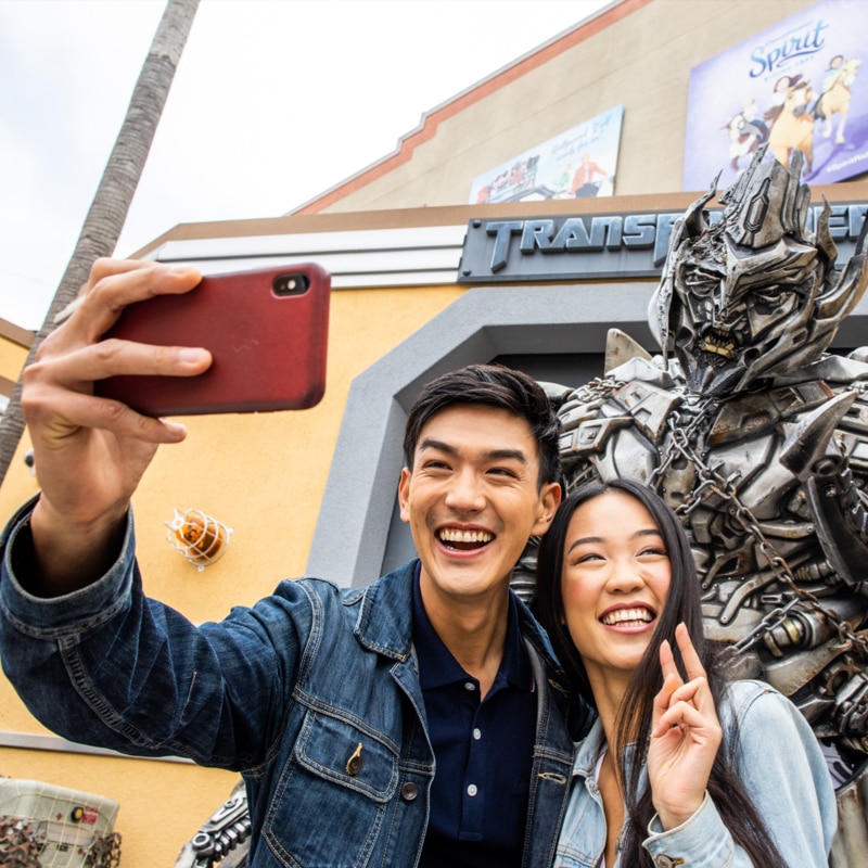 Couple taking a selfie with Megatron.