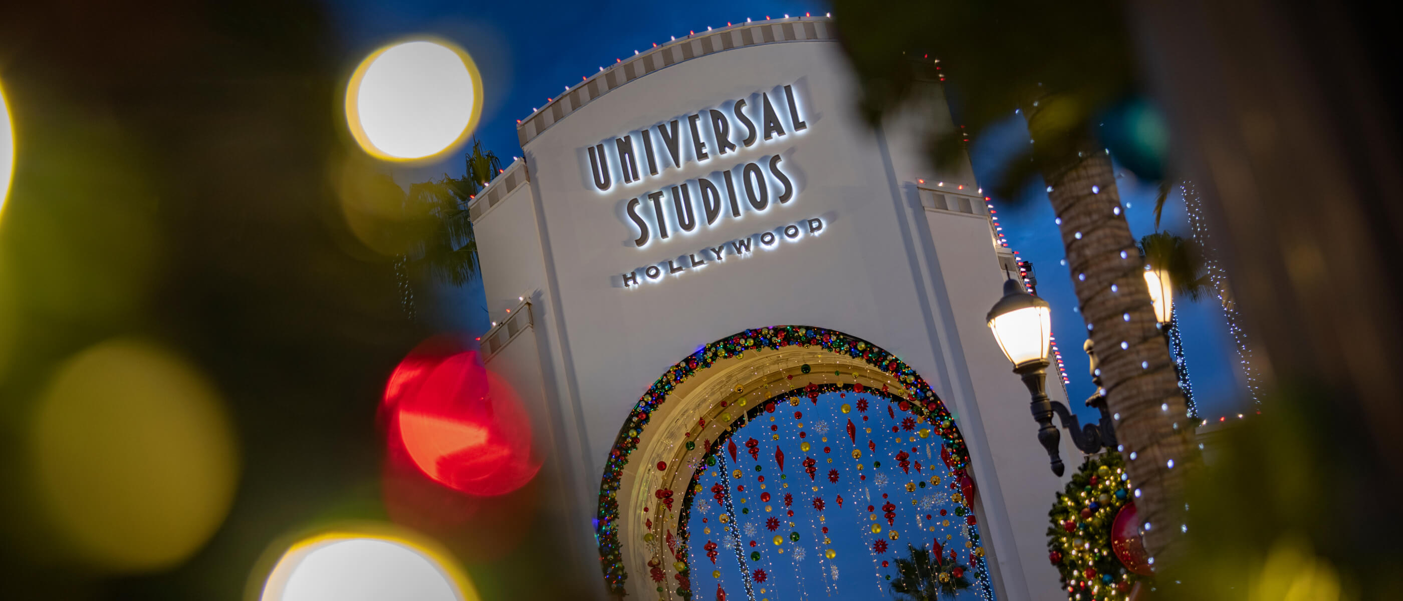 The iconic Universal Studios Hollywood entrance arch beautifully decorated for the holidays.
