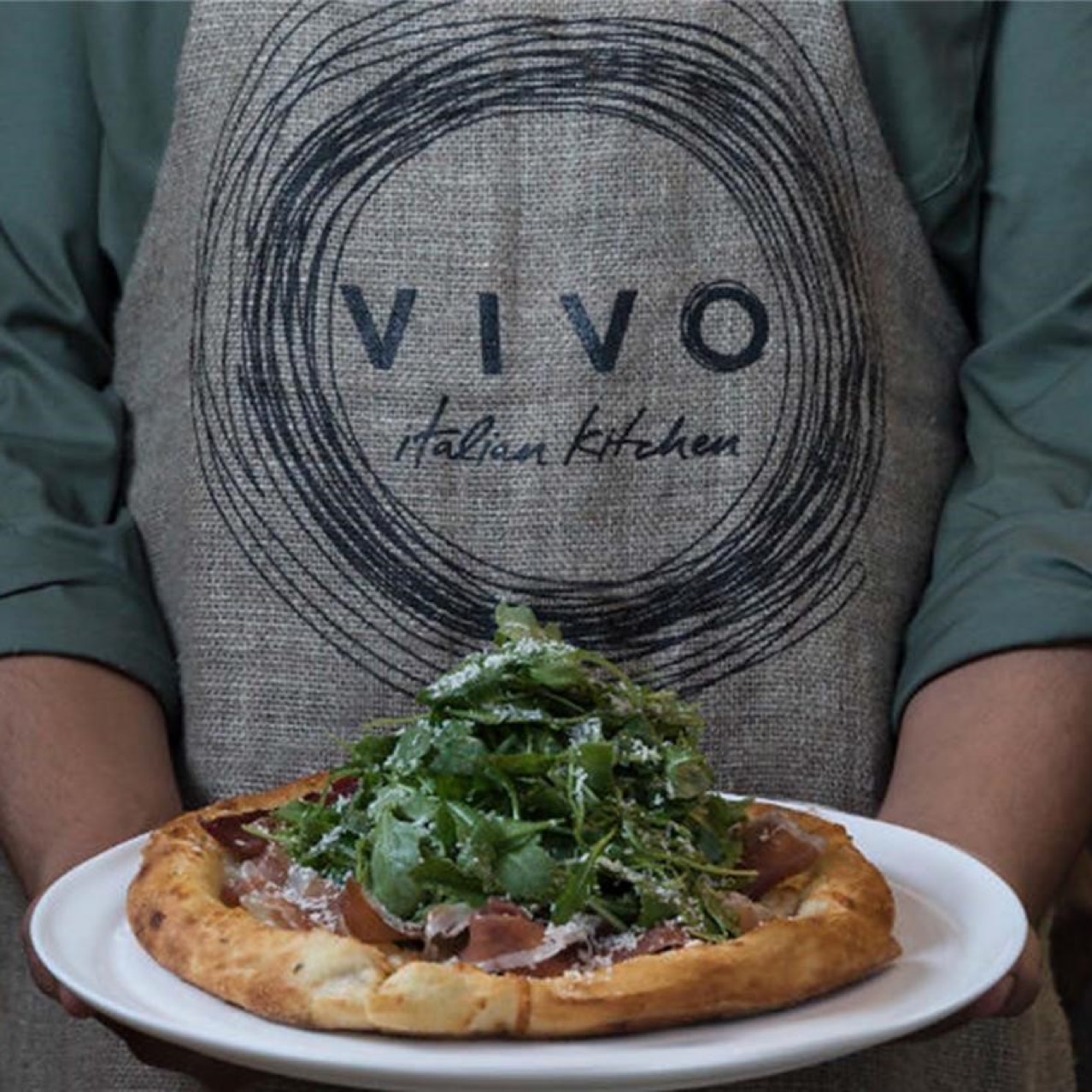 Waiter at VIVO Italian Kitchen holding tray.