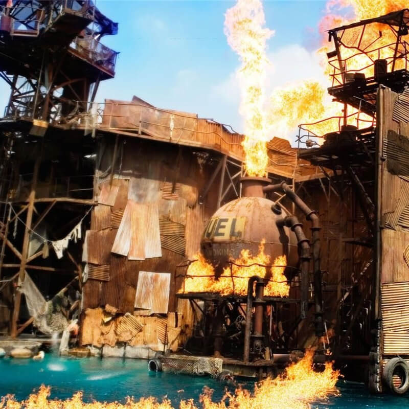 Buildings made of metal sheets on fire above the water.