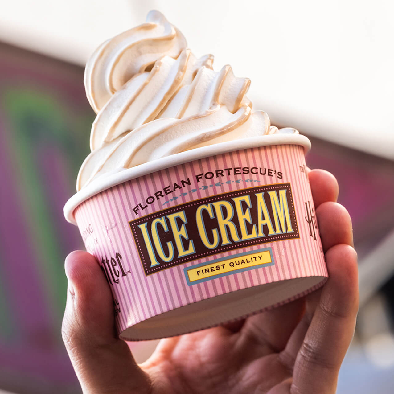 A hand holding a cup of soft serve ice cream from Florean Fortescue's Ice-Cream Counter at Universal Studios Hollywood.